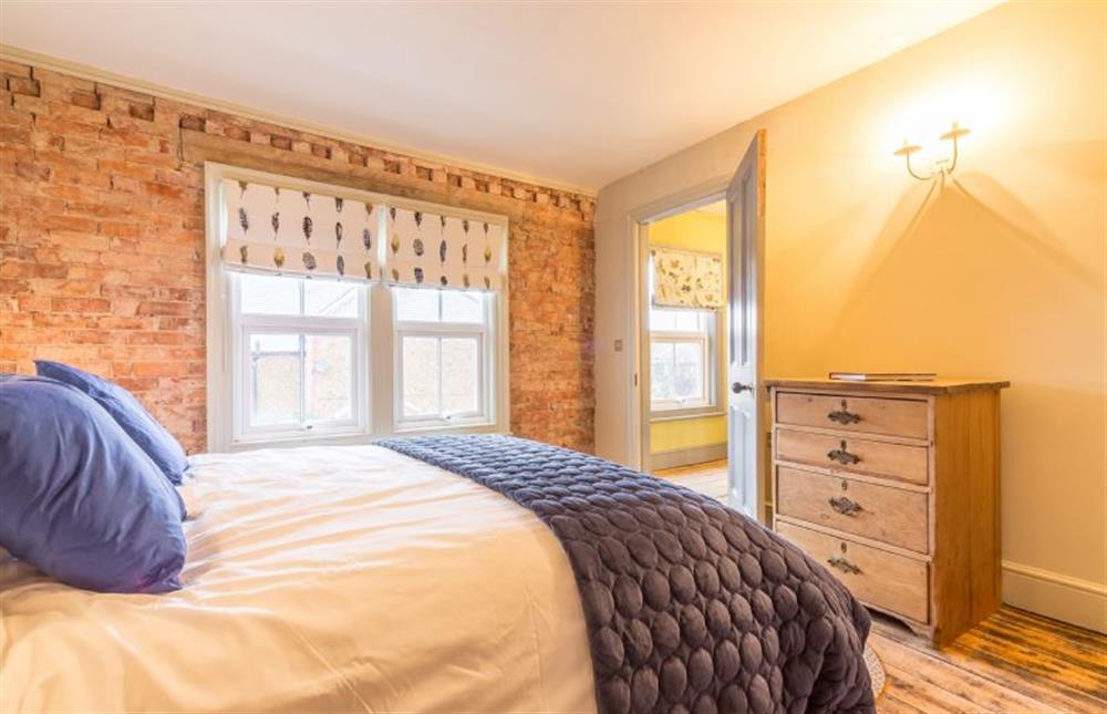 First floor: Master bedroom with king-size bed at The Old Butchers Shop, Heacham near Kings Lynn