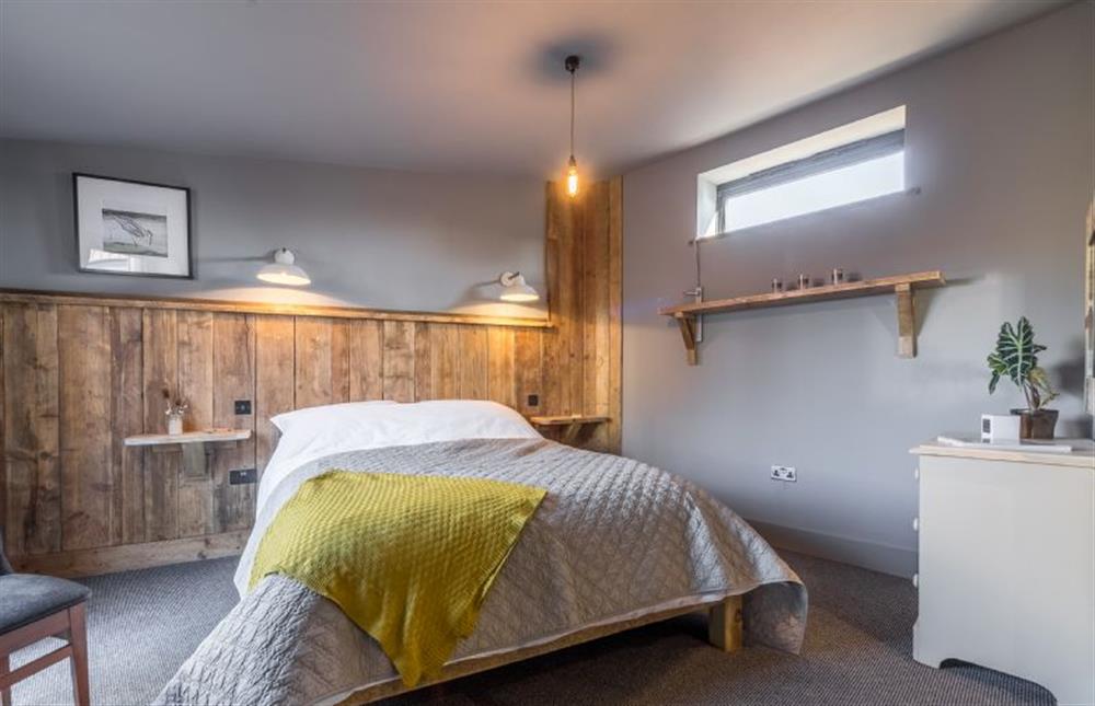 Ground floor: The master bedroom has a luxurious double bed at The Old Butchers Stores, Heacham near Kings Lynn