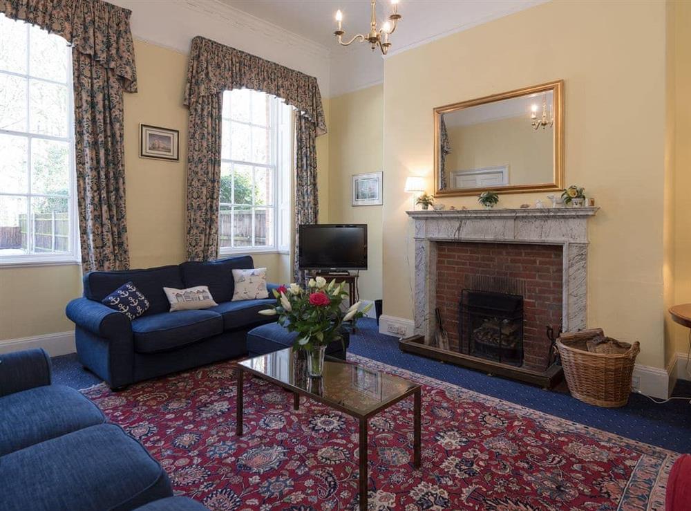 Attractive living room with an open fire at The Old Butlers House in Cley-next-the-Sea, Norfolk., Great Britain