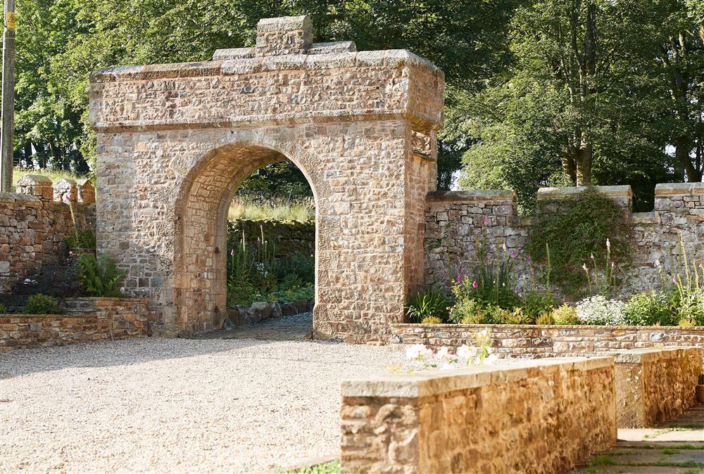 Arch with a stone dated 1871 in the grounds of Rotherhope Towers