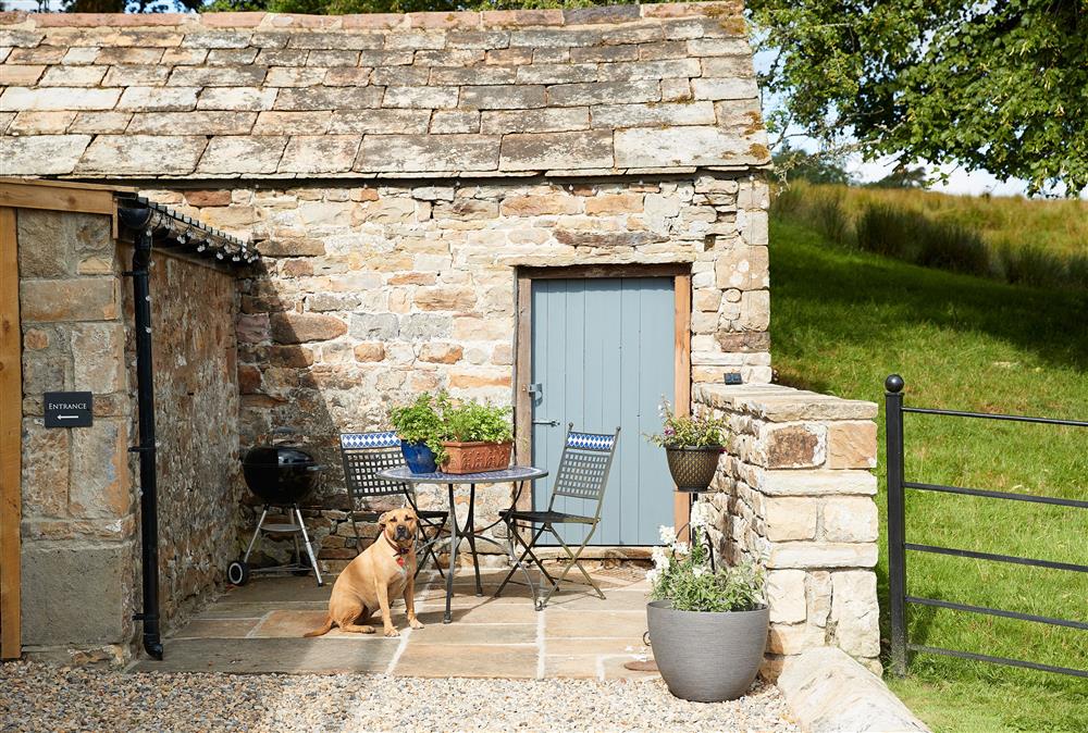 Outside: Patio area with bistro table and chairs at The Old Buttress at Rotherhope Towers, Alston