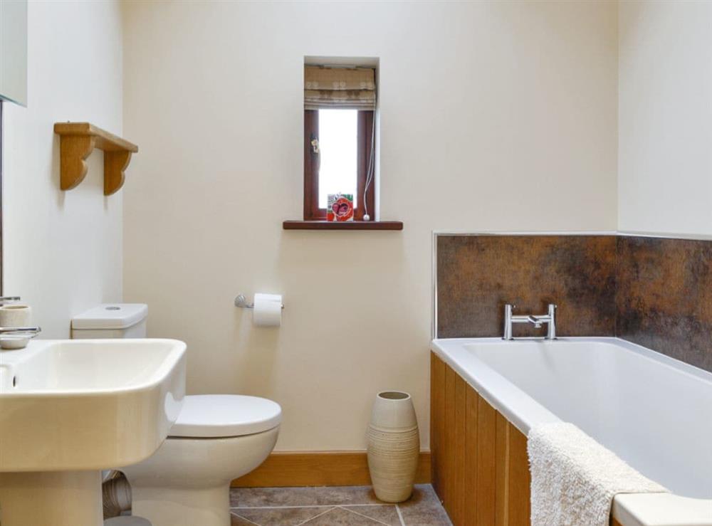Family bathroom with bath and separate shower cubicle at The Old Byre in Dearham, near Maryport, Cumbria
