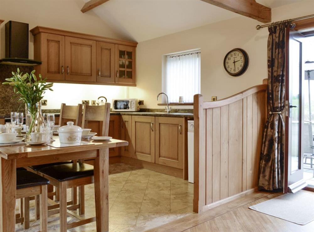 Fully appointed kitchen with dining area at The Old Byre in Dearham, near Maryport, Cumbria