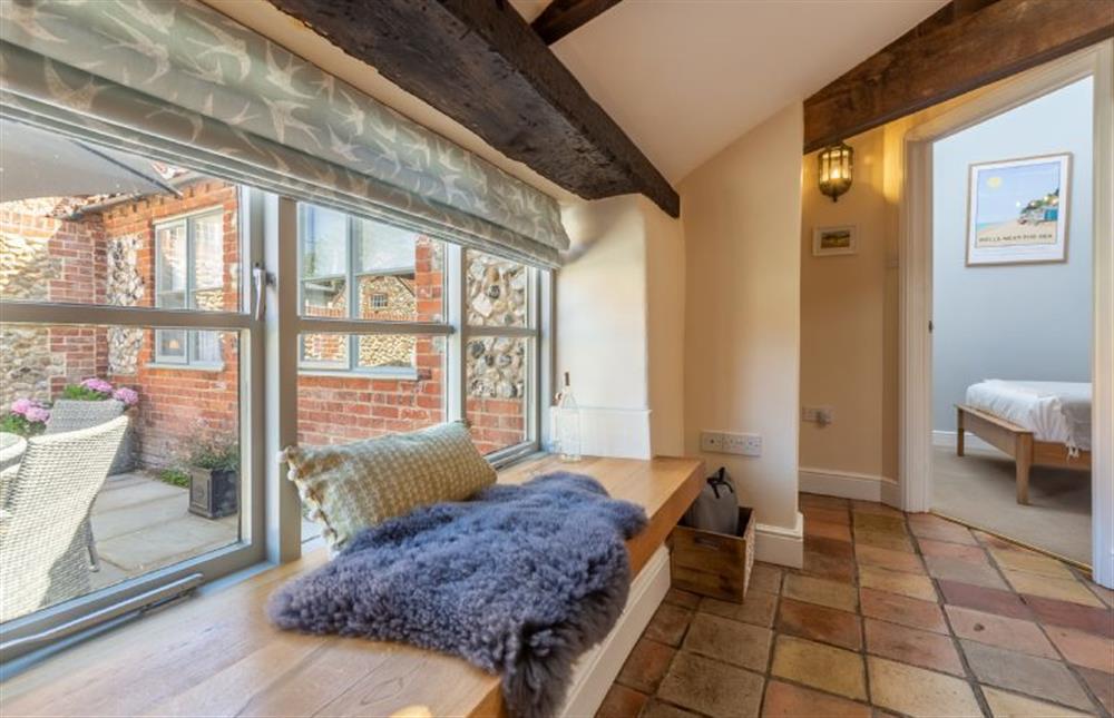Ground Floor: A window seat overlooking the courtyard garden at The Old Chapel, Great Walsingham