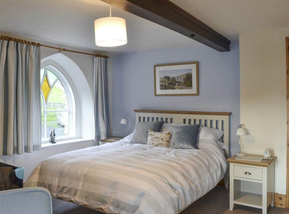 Comfortable double bedroom with additional cot facility at The Old Chapel in Thoralby, near Leyburn, North Yorkshire