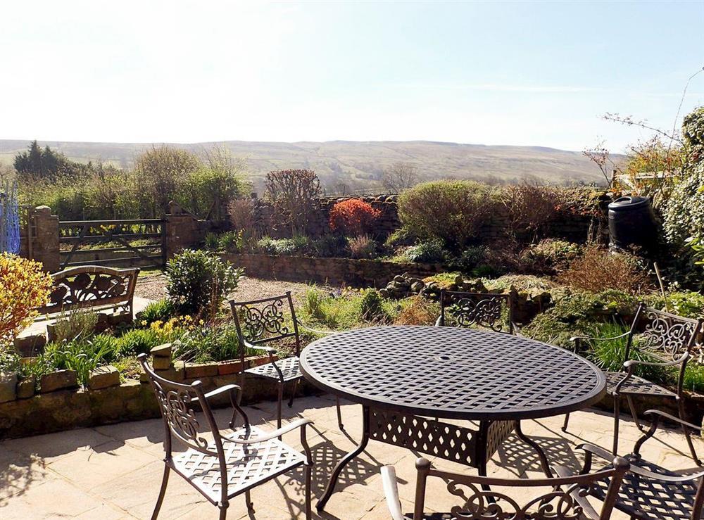 Well-maintained garden with terraced patios and outdoor furniture at The Old Chapel in Thoralby, near Leyburn, North Yorkshire