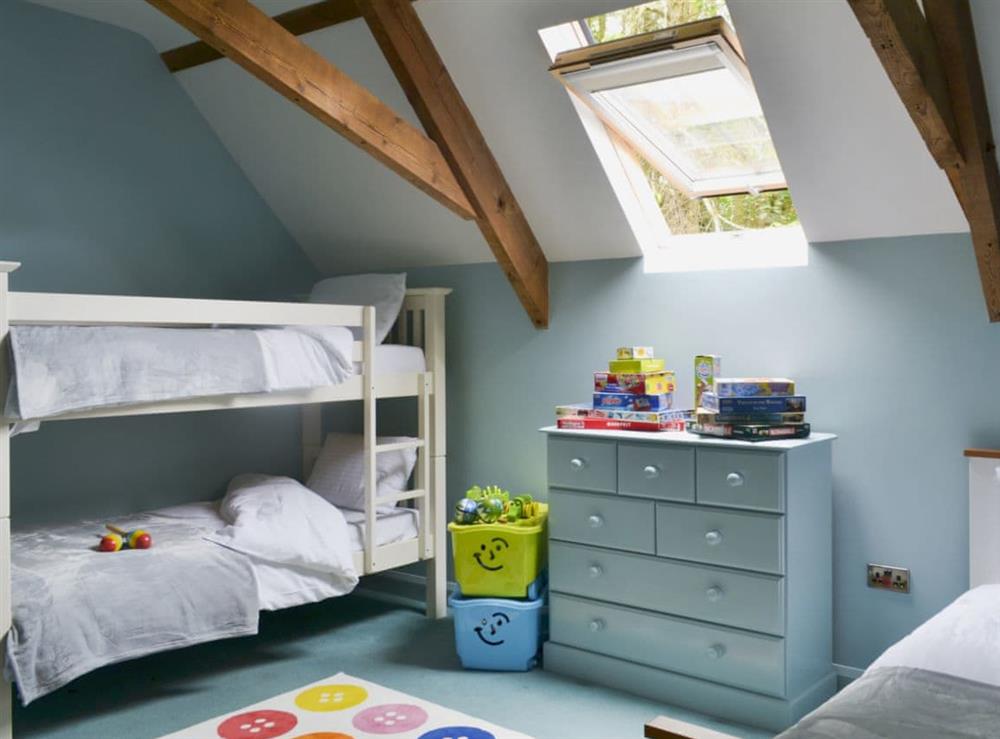 Bedroom with bunk bed and single bed at The Old Classroom in St Neot, near Liskeard, Cornwall, England