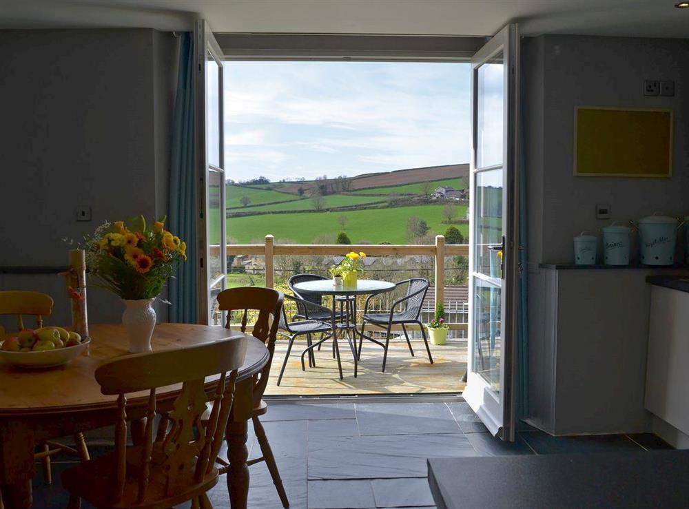 Kitchen/dining area with French doors leading to balcony at The Old Classroom in St Neot, near Liskeard, Cornwall, England