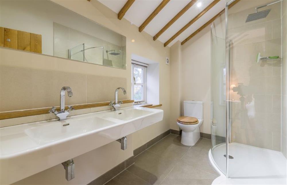 First floor: En-suite shower room has double basin and walk-in shower at The Old Coach House, Brancaster Staithe near Kings Lynn