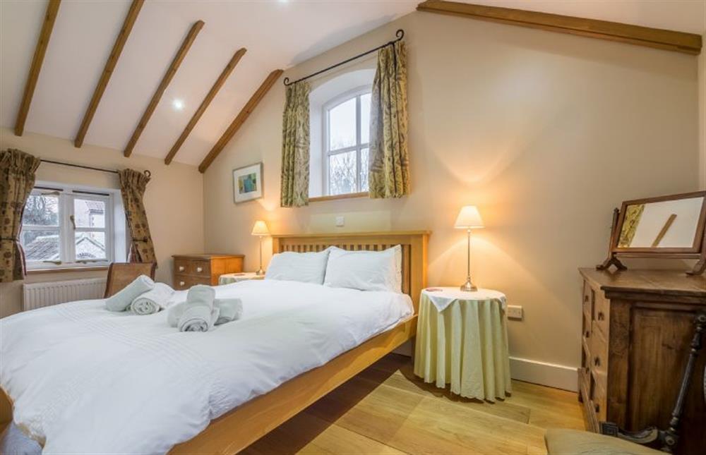 First floor: Master bedroom has en-suite shower room at The Old Coach House, Brancaster Staithe near Kings Lynn