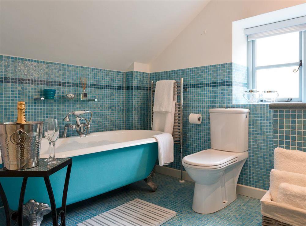 Attractively tiled bathroom boasting a stand alone bath tub at The Old Coach House in Colyton, near Honiton, Devon