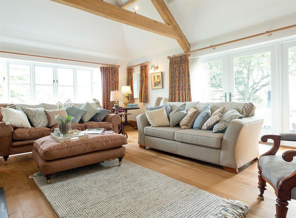 Grand living room with beamed ceiling and woodburner (photo 2) at The Old Coach House in Colyton, near Honiton, Devon