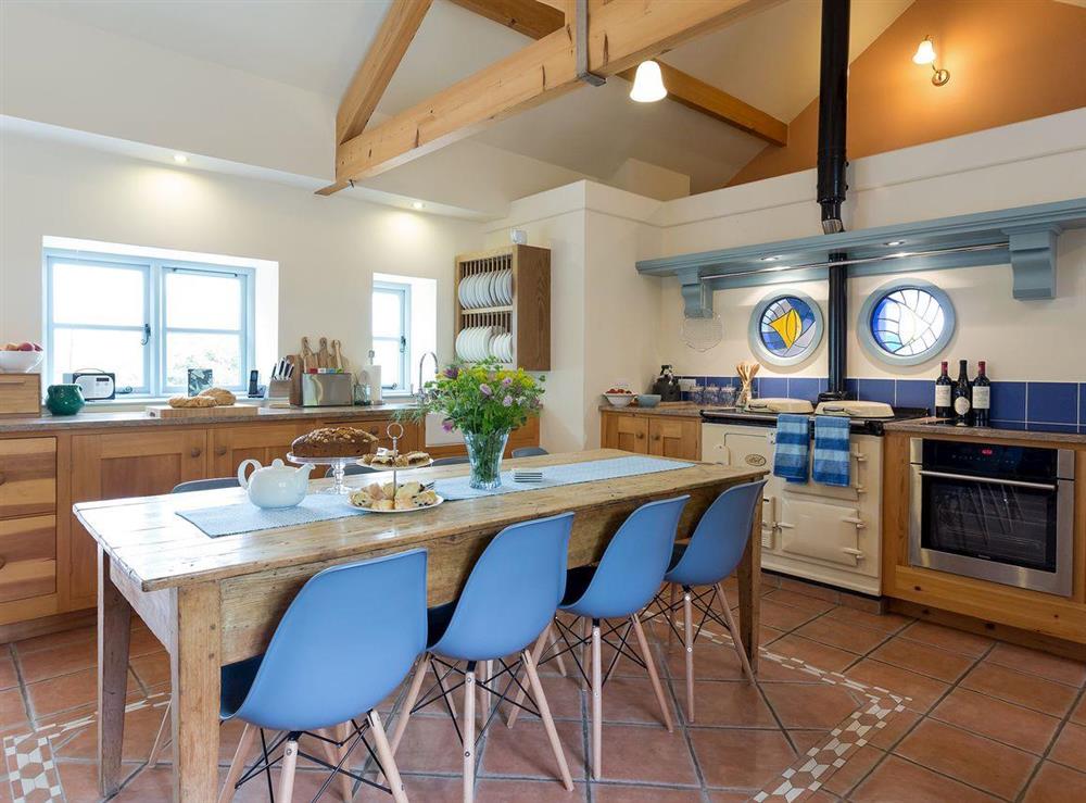 Spacious farmhouse style kitchen with large family sized dining table at The Old Coach House in Colyton, near Honiton, Devon
