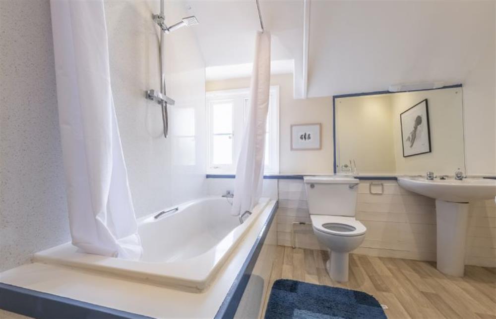 Master bathroom with large bath and shower over at The Old Coach House, Congham near Kings Lynn