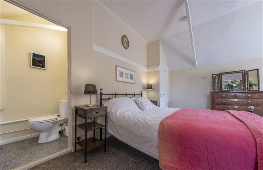 Master bedroom with 5’ king-size bed and WC at The Old Coach House, Congham near Kings Lynn