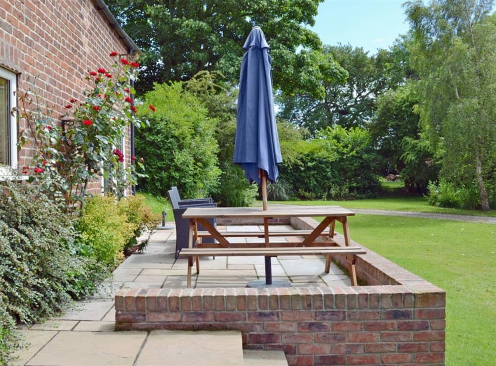 Patio seating overlooking garden at The Old Coach House in Driffield, North Humberside