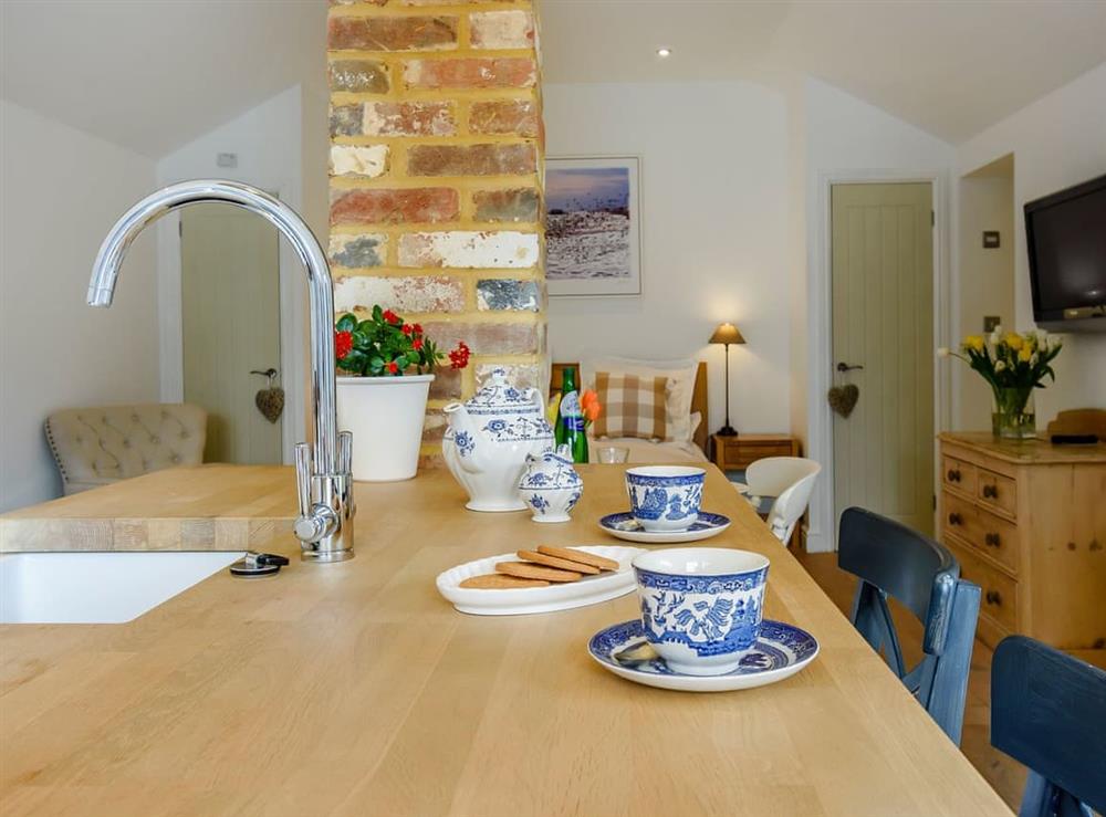 Well-equipped kitchen area with breakfast bar at The Old Dairy At Wootton in East Chiltington, East Sussex