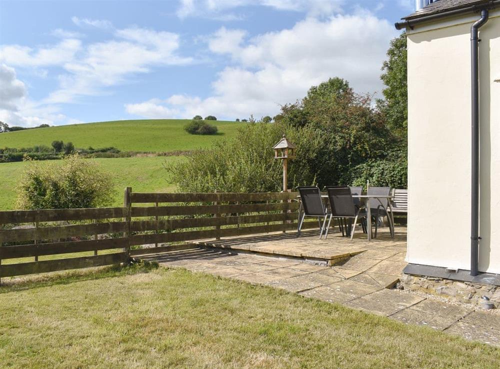 Enclosed garden area with patio at The Old Dairy in Thorncombe, near Broadwindsor, Dorset, England