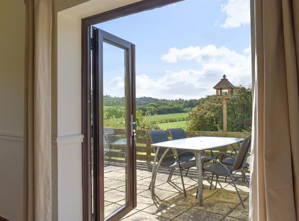 French doors to patio area and garden at The Old Dairy in Thorncombe, near Broadwindsor, Dorset, England
