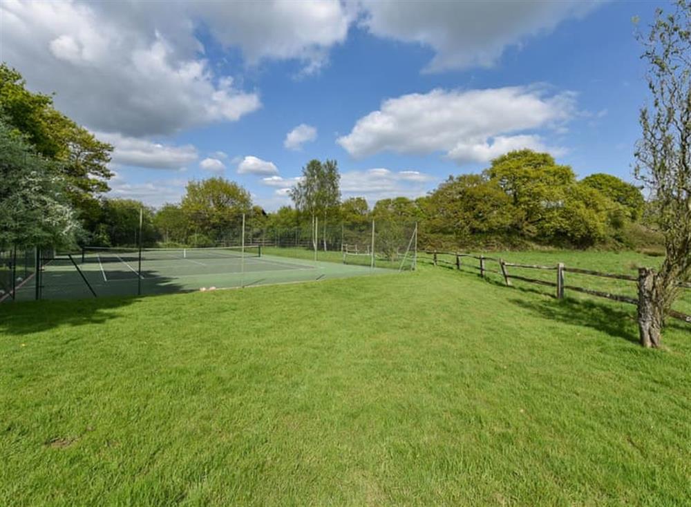 Tennis court at The Old Dairy in West Chiltington, Sussex