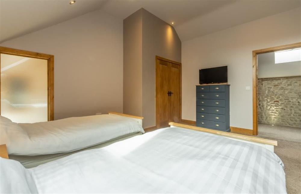 First floor: Bedroom four with Smart television at The Old English Barn and Cart Shed, Paston near North Walsham