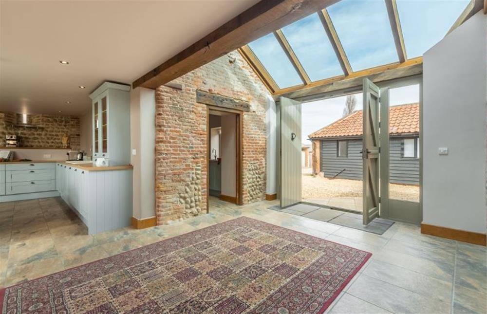 Ground floor: Enter in to lovely open-plan living area - view to utility and kitchen with The Cart Shed annexe behind