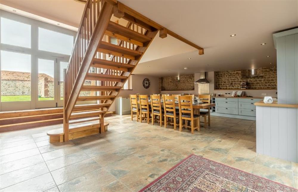 Ground floor: Kitchen and dining area with doors to enclosed garden at The Old English Barn and Cart Shed, Paston near North Walsham