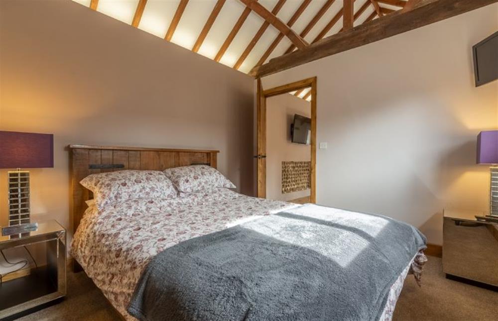 Ground floor: Master bedroom at The Old English Barn and Cart Shed, Paston near North Walsham