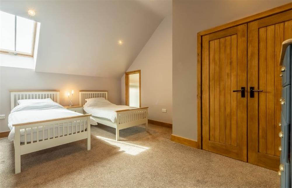 First floor: Bedroom four is a twin bedroom with two 3ft single beds at The Old English Barn, Paston near North Walsham
