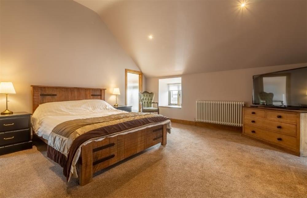 First Floor: Master bedroom with super-king bed and Smart television at The Old English Barn, Paston near North Walsham