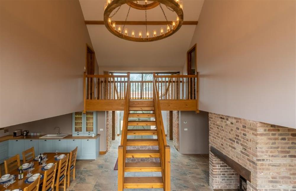 Ground floor: Stairs to first floor accommodation at The Old English Barn, Paston near North Walsham