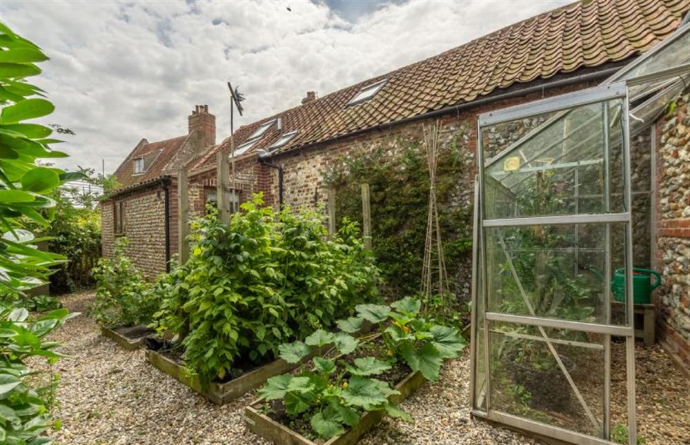 The rear of the cottage has enclosed gardens at The Old Forge, Binham near Fakenham