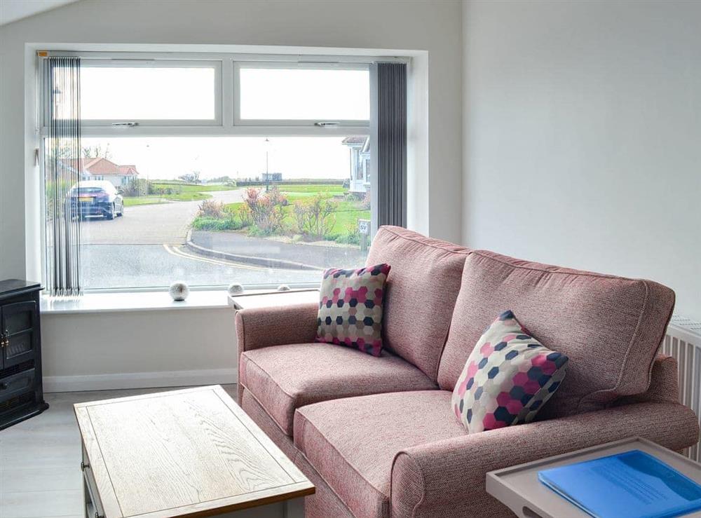 Comfortable living area with a view of the sea at The Old Forge Cottage in Sewerby, near Bridlington, North Humberside