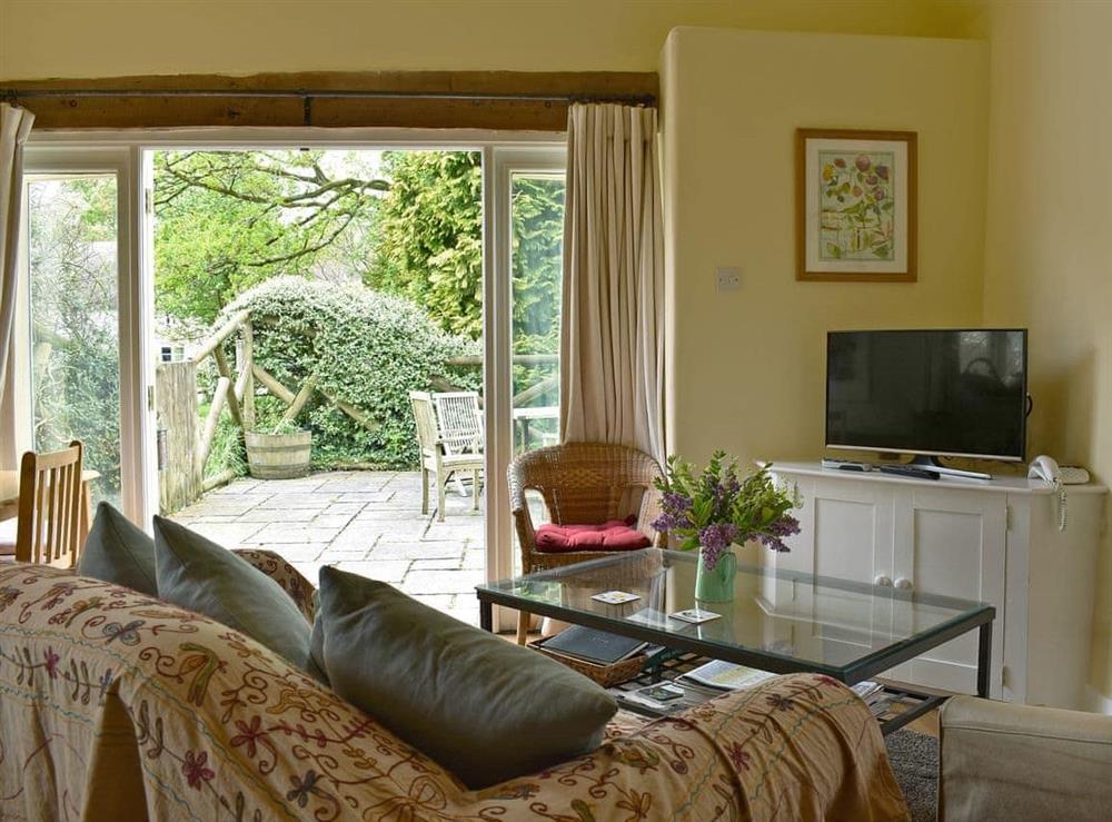 Welcoming living area with French doors to garden at The Old Forge in Lower Wraxall, Nr Dorchester., Dorset