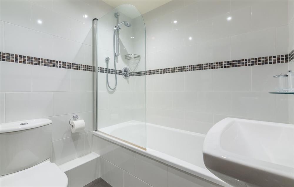 En-suite bathroom with bath and overhead shower at The Old Foundry, Eastmoor