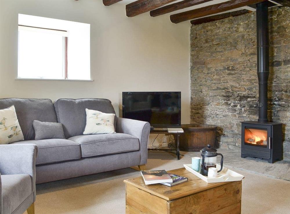 Inviting living area with wood burner at The Old Granary in Holy Island, near Berwick-upon-Tweed, Northumberland
