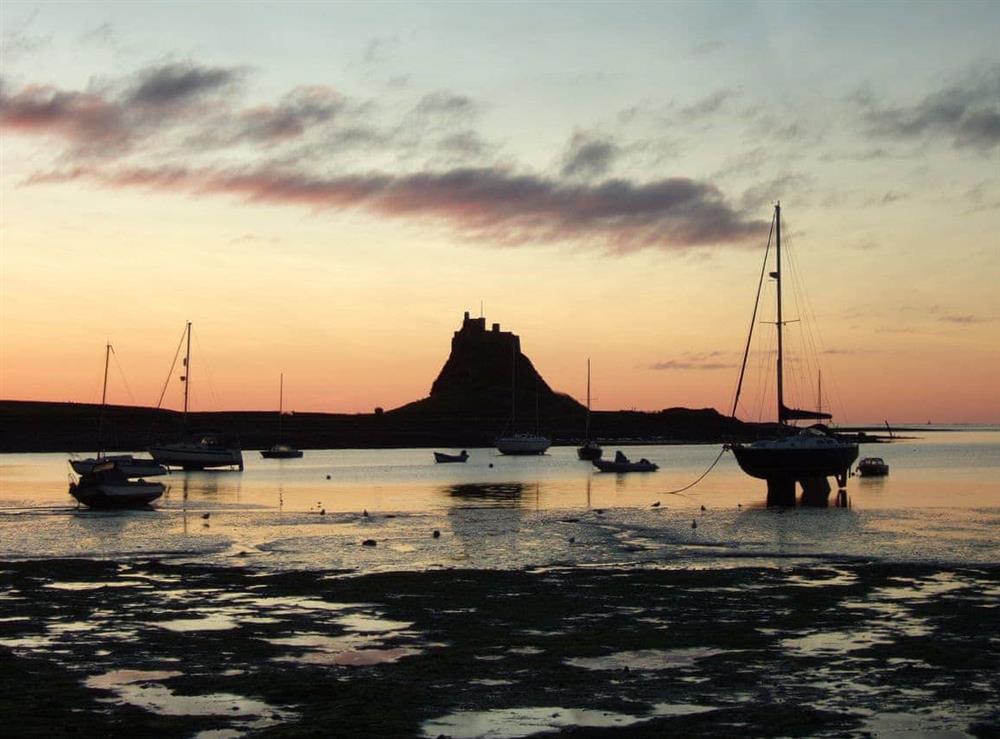Lindisfarne Castle and harbour at sunrise at The Old Granary in Holy Island, near Berwick-upon-Tweed, Northumberland