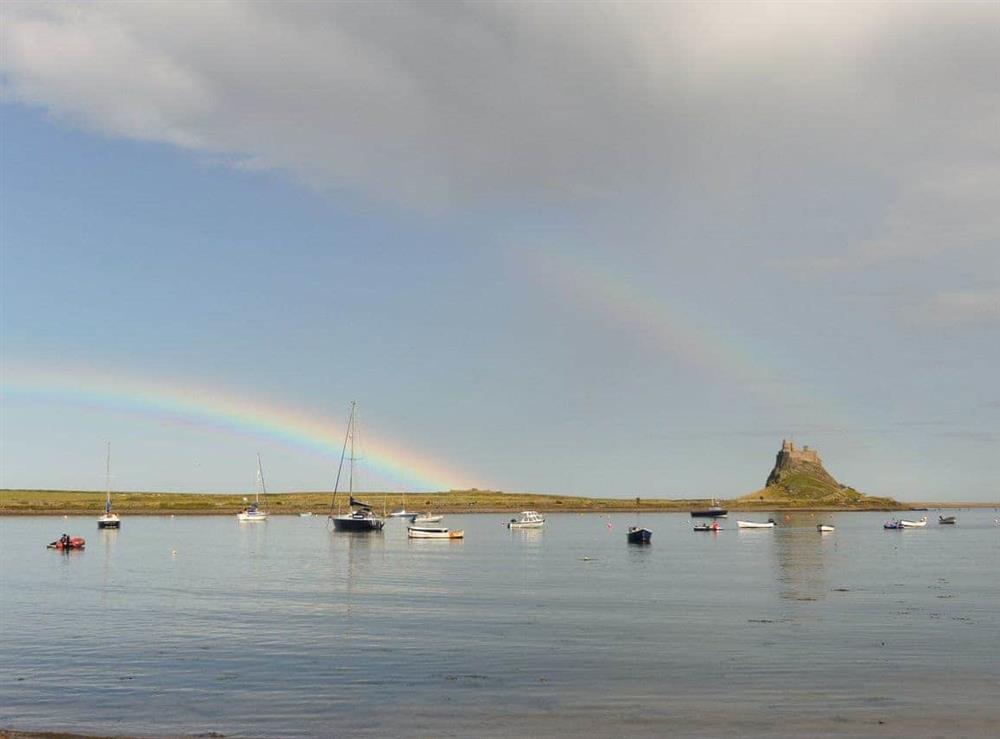 Lindisfarne Castle and harbour at The Old Granary in Holy Island, near Berwick-upon-Tweed, Northumberland