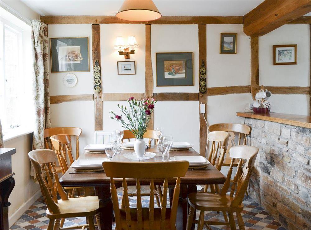 Stylish dining area with exposed wooden framework at The Old Granary in Newent, Gloucester, Gloucestershire