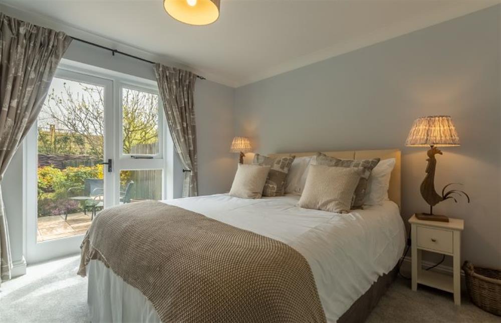 Ground floor:  Master bedroom with french doors to rear garden at The Old Joinery, Cley-next-the-Sea near Holt