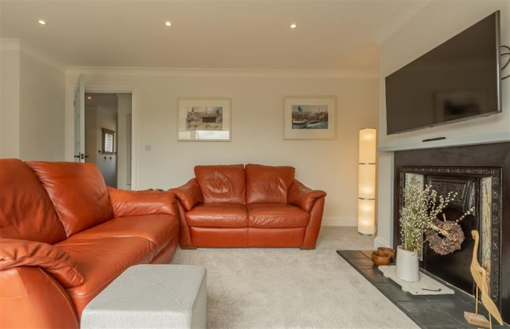 Ground floor:  Sitting area with flatscreen television and comfy sofas