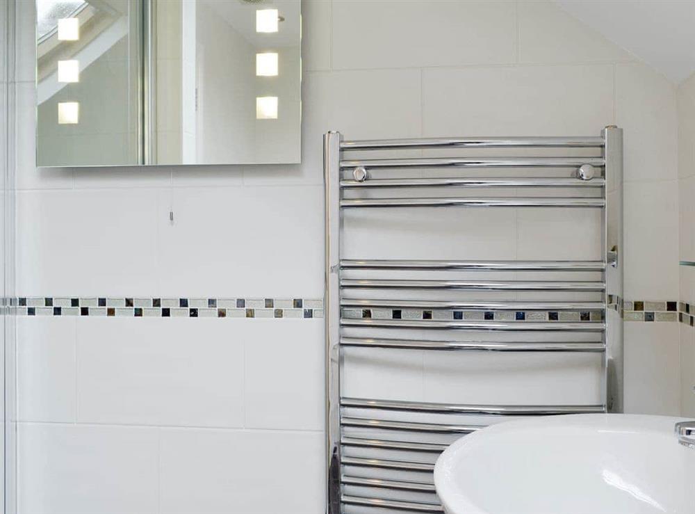 Family bathroom with shower cubicle and separate bath at The Old Laundry 4 in Keswick, Cumbria