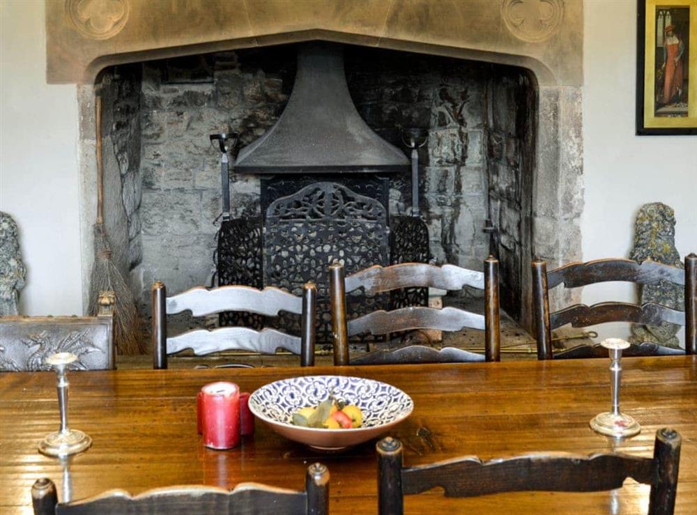 Dining room with wood burning stove at The Old Manor in Dunster, near Minehead, Somerset