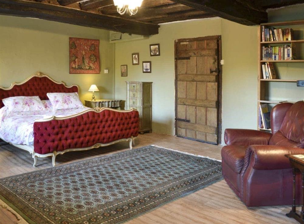 Large double bedroom with exposed beamed ceiling at The Old Manor in Dunster, near Minehead, Somerset