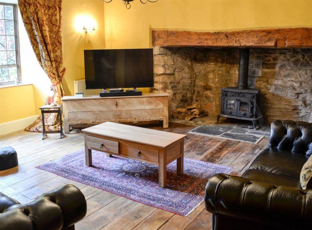 Lounge area with wood burner at The Old Manor in Dunster, near Minehead, Somerset