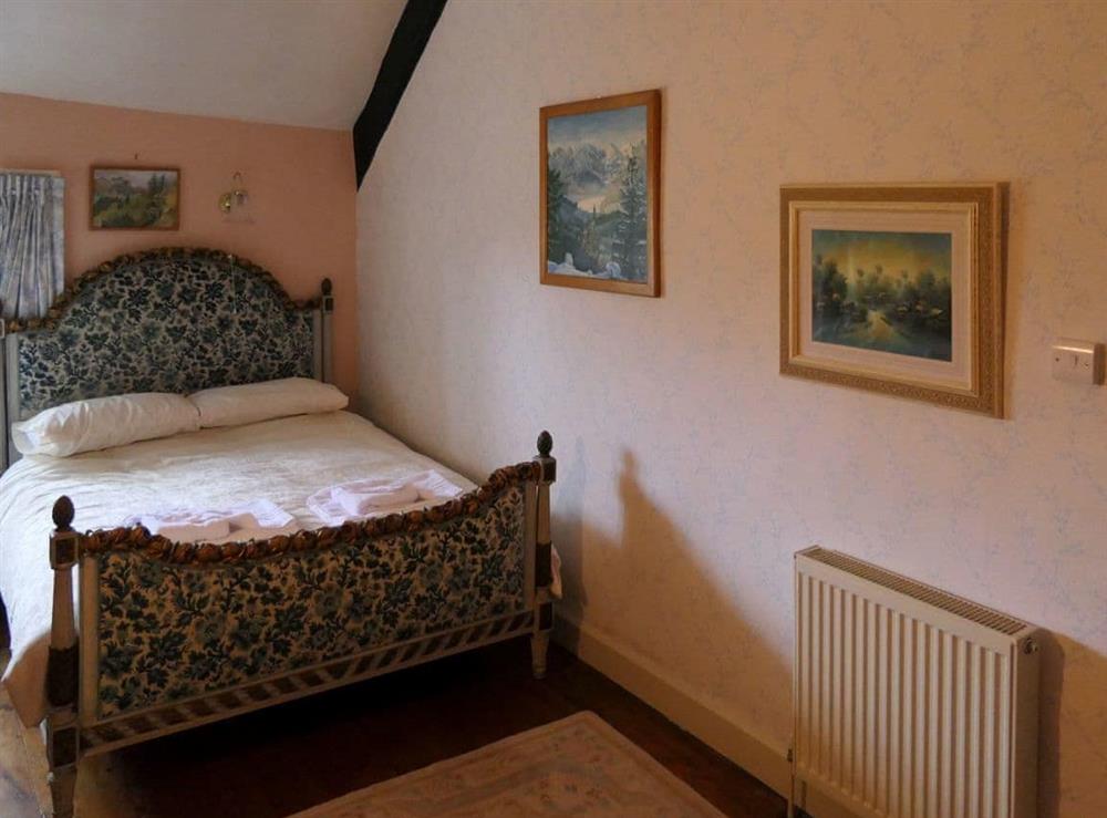 Pretty bedroom with kingsize bed at The Old Manor in Dunster, near Minehead, Somerset