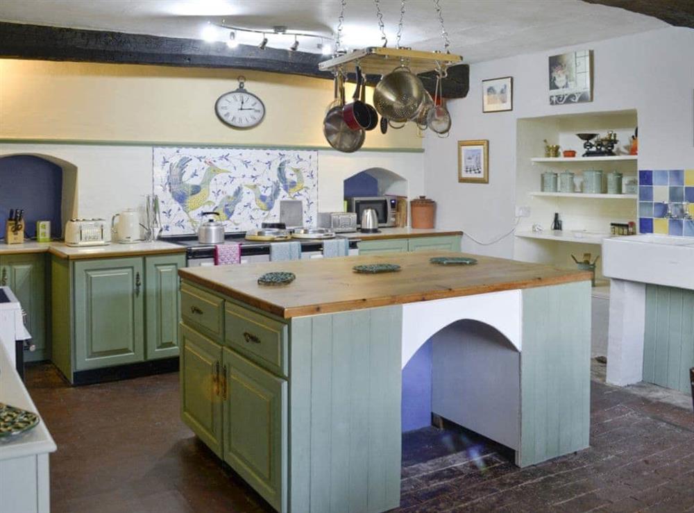 Spacious kitchen with central-island at The Old Manor in Dunster, near Minehead, Somerset