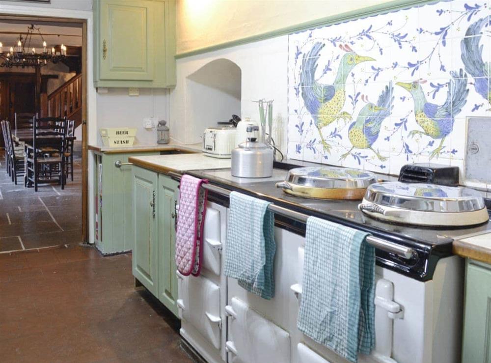 Well-appointed kitchen situated next to formal dining room at The Old Manor in Dunster, near Minehead, Somerset