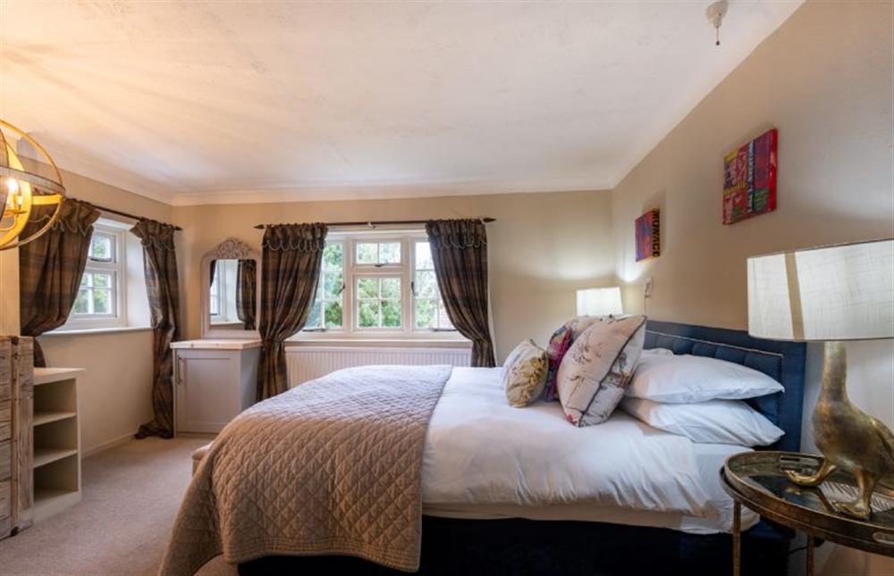Bedroom two with king-size bed and feature lighting at The Old Manor House, Brancaster near Kings Lynn