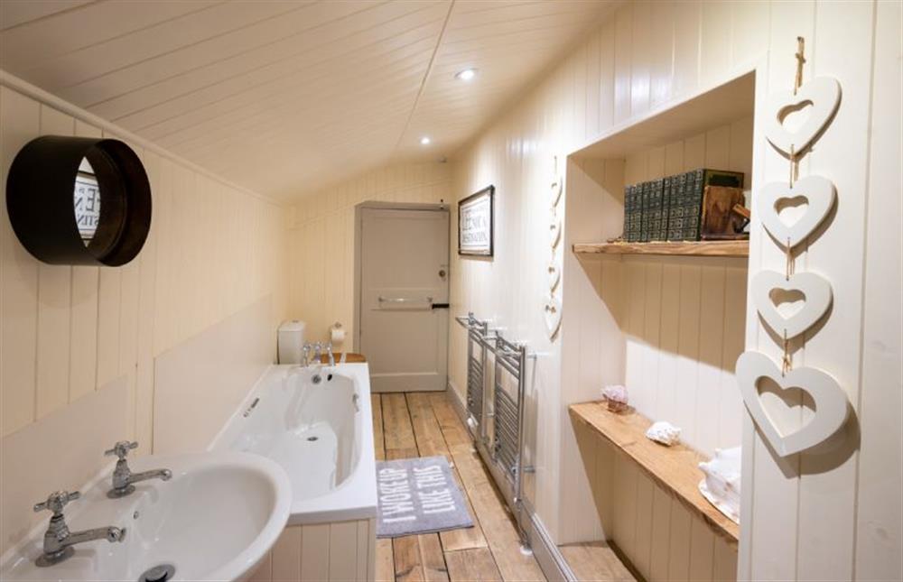 Family bathroom with heated towel rails at The Old Manor House, Brancaster near Kings Lynn